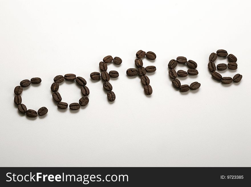 The word coffee written with coffee beans