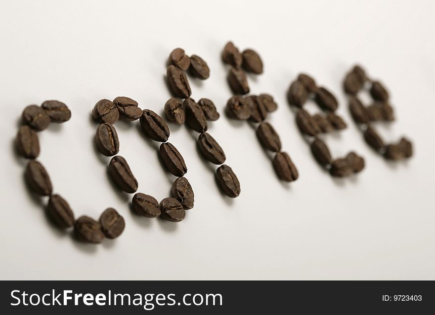 The word coffee written with coffee beans