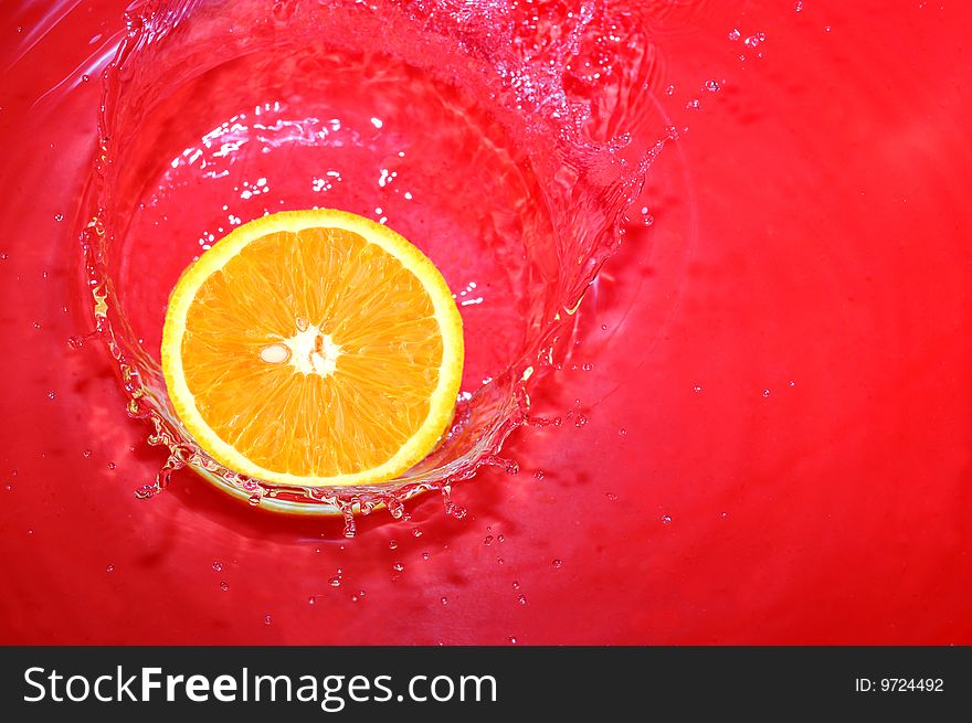 Orange is falling in water