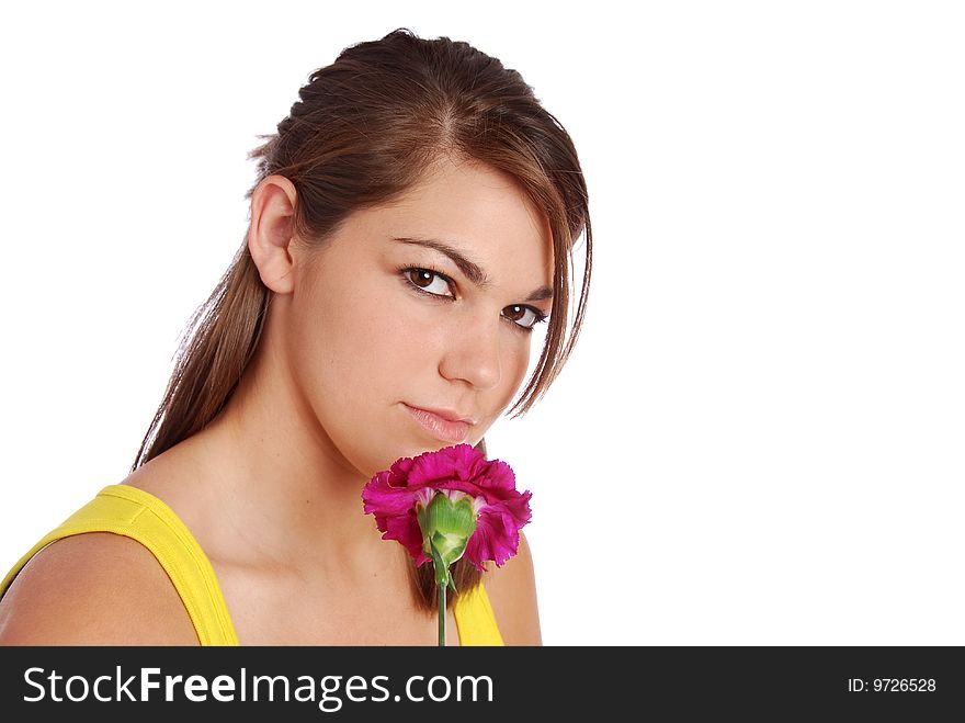 A pretty young woman looking thoughtful and holding a flower. A pretty young woman looking thoughtful and holding a flower.