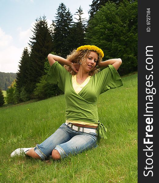 Curly girl with dandelion chain on head