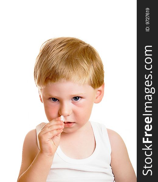 The sick little boy digs in drops in a nose. The sick little boy digs in drops in a nose