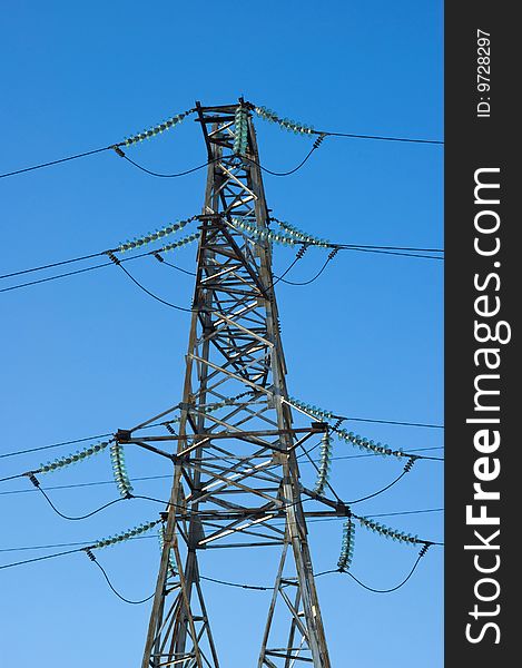 High-voltage line electrified  on background blue sky. High-voltage line electrified  on background blue sky