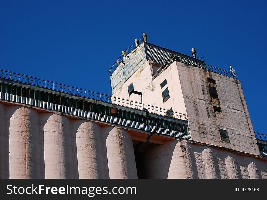 Detail of a tall silo against blue sky