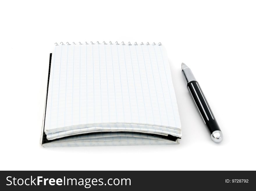An opened blank notepad and a pen. An opened blank notepad and a pen