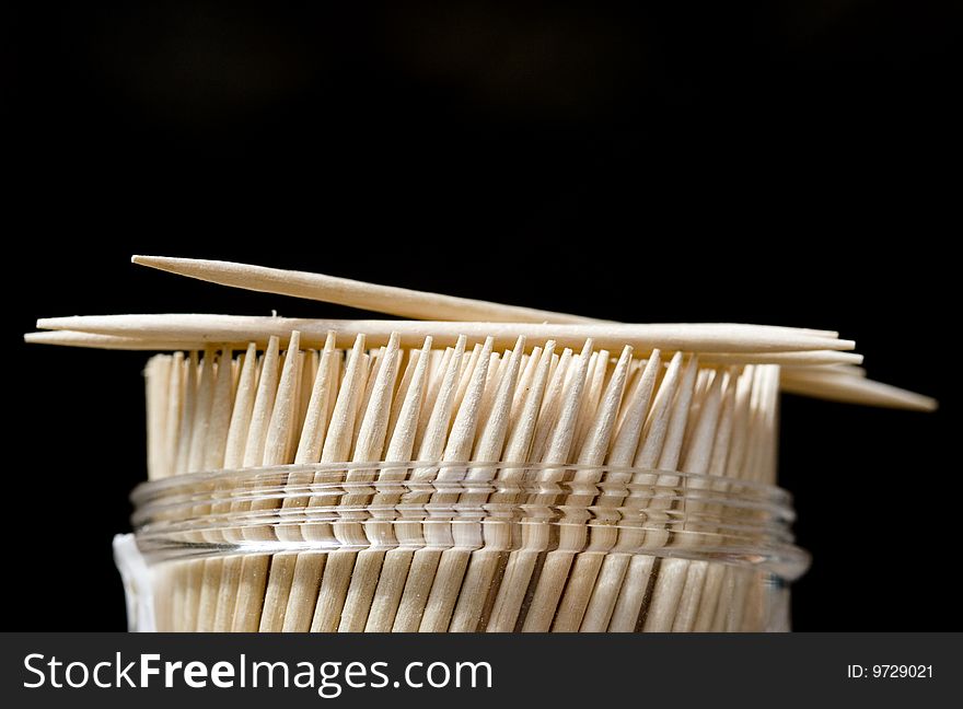 Close up of toothpick on a black background