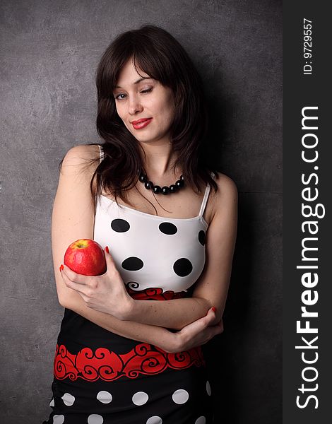 Coquettish, sexual woman with a red apple