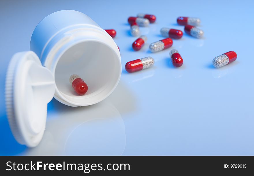 Tablets and a jar on a blue background. Tablets and a jar on a blue background