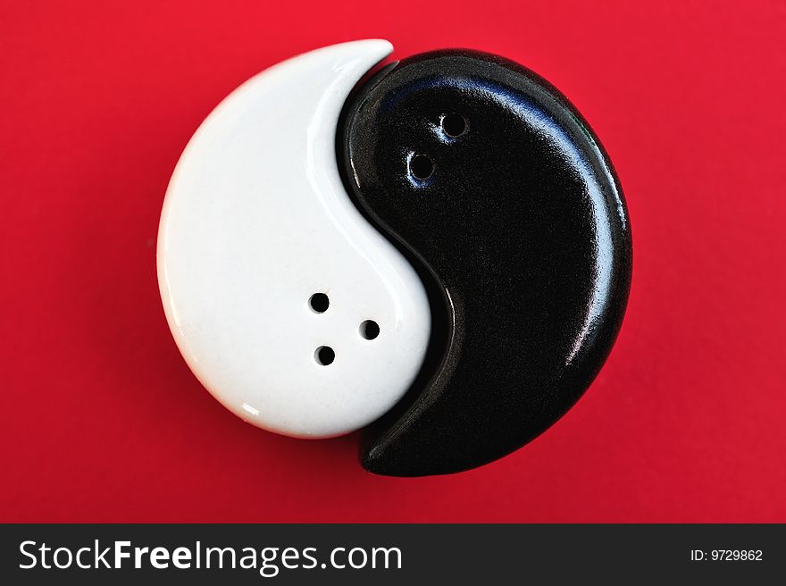 Graphic symbol of Yin and Yang, on a red background. Graphic symbol of Yin and Yang, on a red background