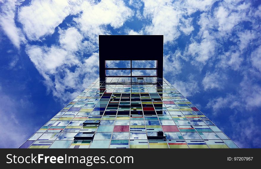 Low Angle Photography of Glass Building Under White Cloud and Blue Sky during Daytime