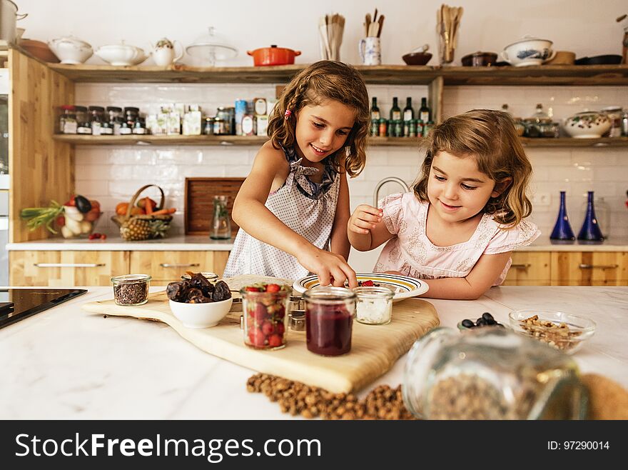 Little sisters girl preparing baking cookies. Infant Chef Concept.