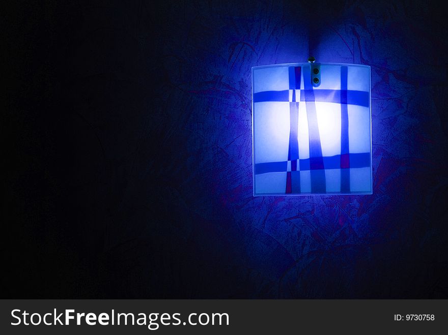 Modern blue lamp over dark background. Modern blue lamp over dark background