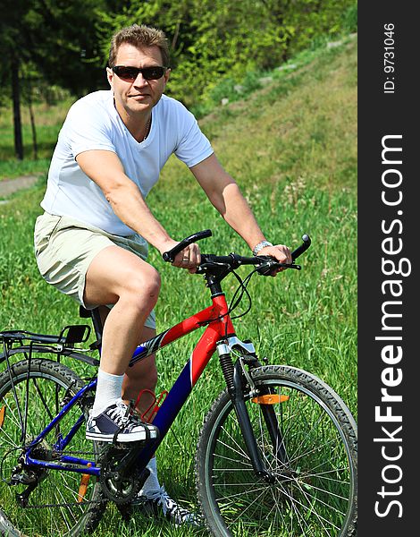 Sporty mature man cycling along cross country. Sporty mature man cycling along cross country.