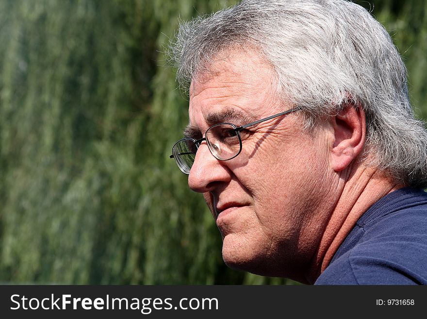 Baby boomer man smiling with gray hair and glasses