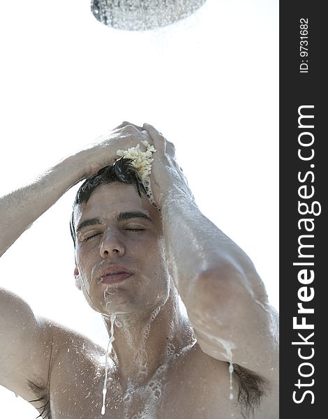 A young man under outdoor shower