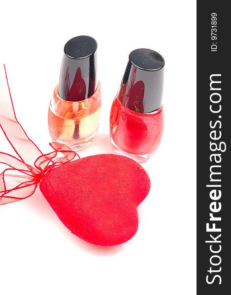 Nail paints with red heart isolated on white background.