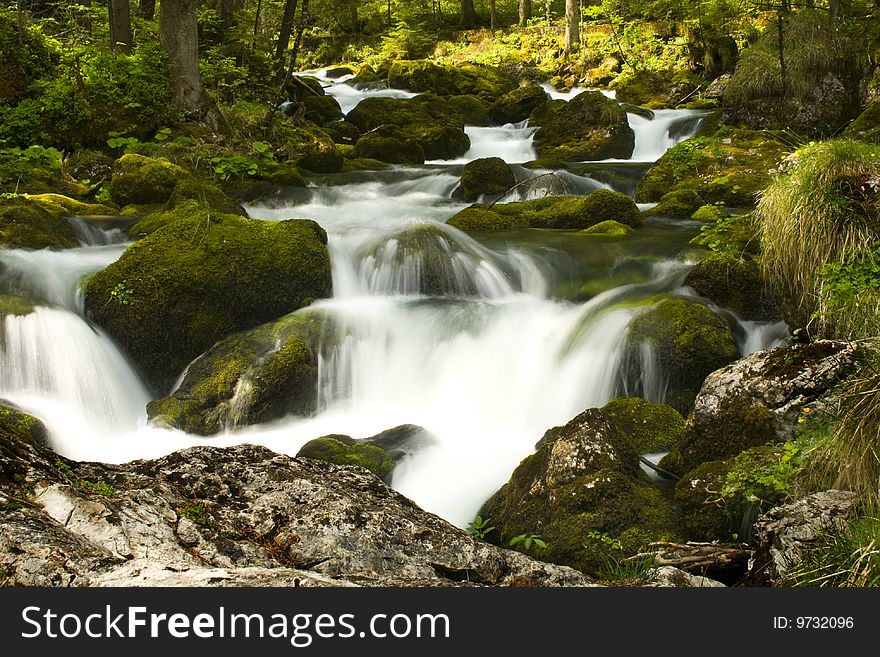 Rapids with stones and moss in the alps