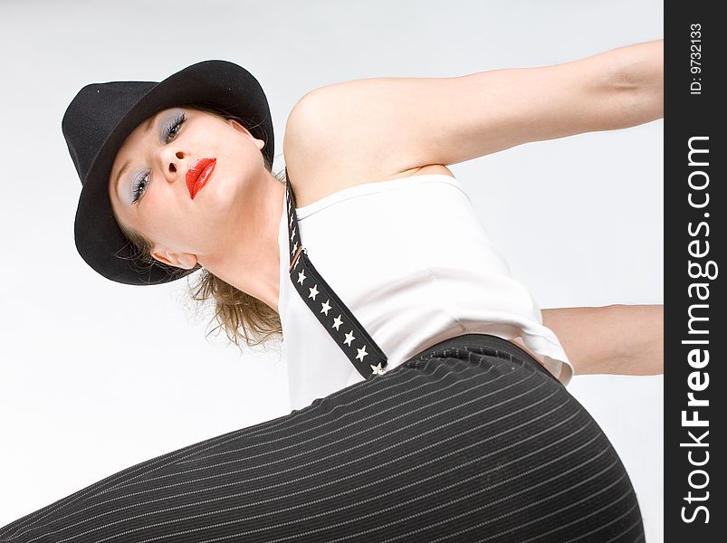 Photo-session in studio of the young blondy girl with black hat