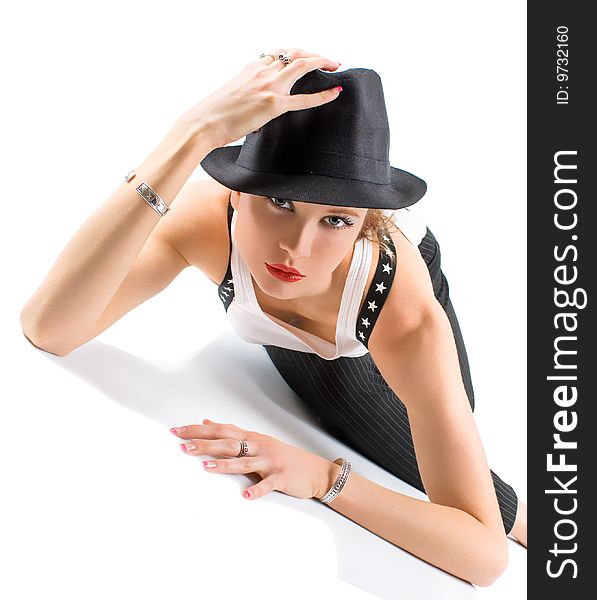 Photo-session in studio of the young blondy girl with black hat