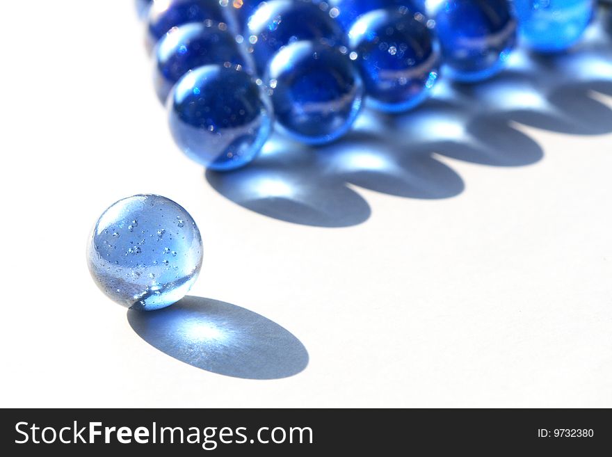 Game of billiards made from blue glass balls isolated on white background. Game of billiards made from blue glass balls isolated on white background