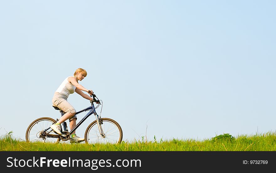 Girl relax biking on green grass