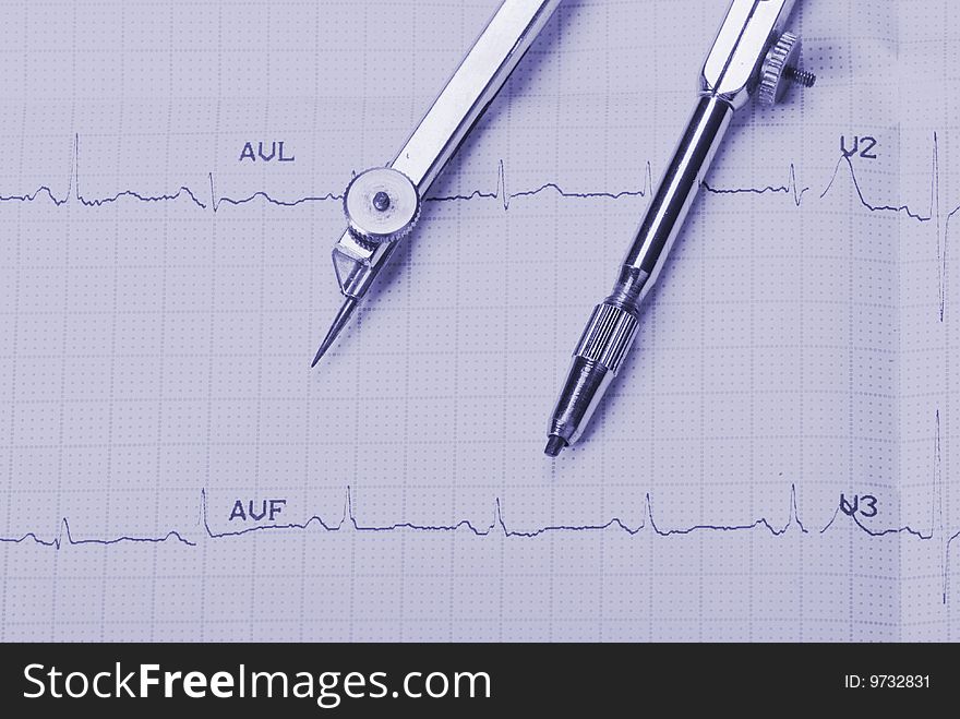 EKG printout and compasses under  monochromatic source