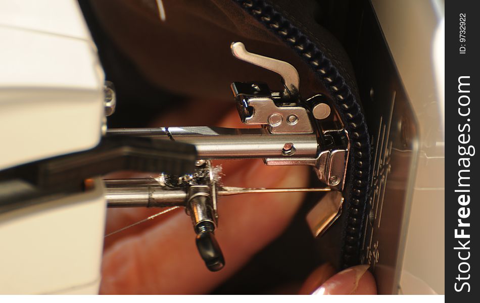 A setail view of a sewing machine. A setail view of a sewing machine.