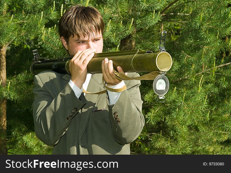 Young manager shoots from a grenade launcher