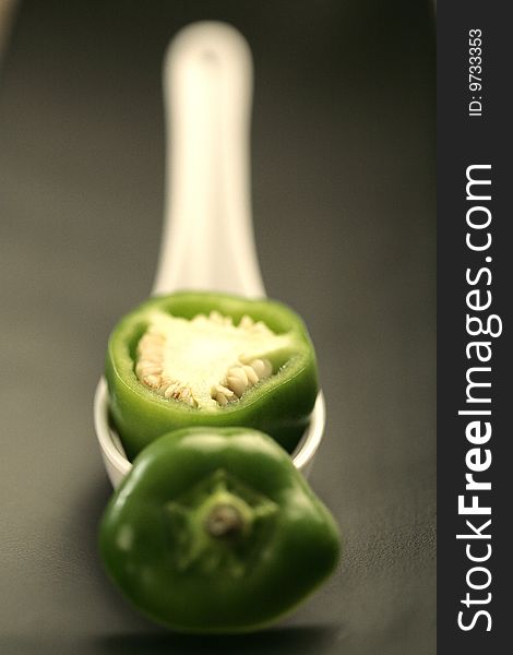 Closeup colored peppers on black plate