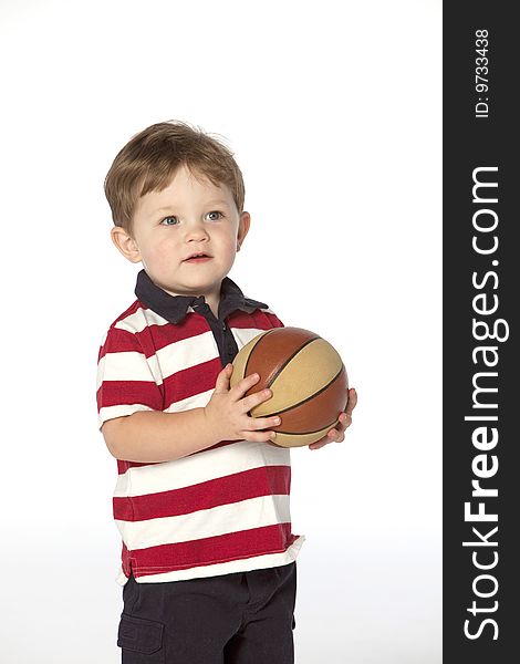 Little boy with basket ball on white background