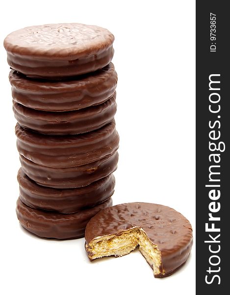 Stack of seven chocolate cookies near a part of it. Stack of seven chocolate cookies near a part of it