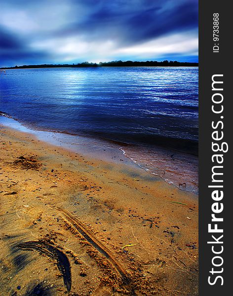 Menacing skies hover above the beach at Petrie Island