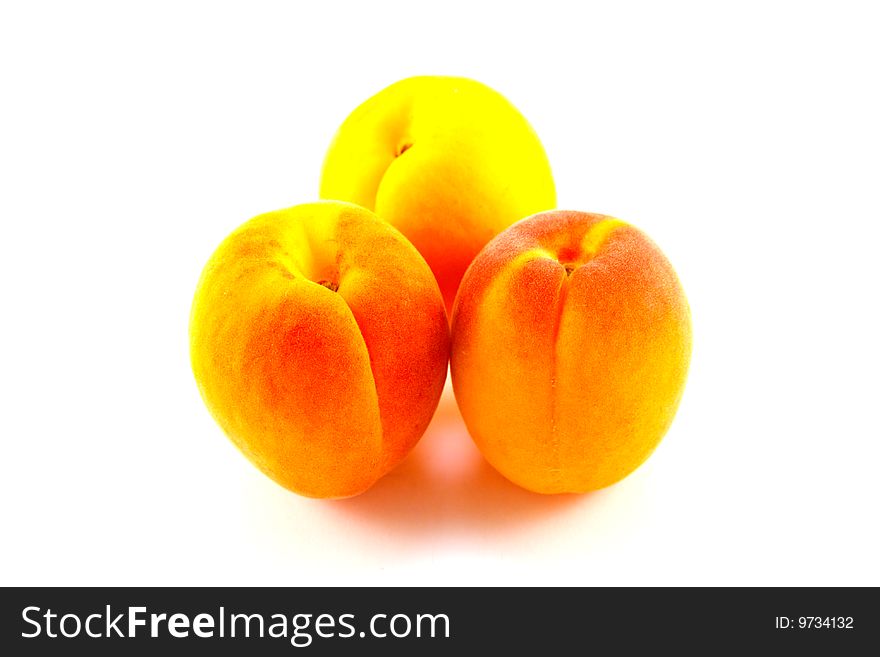Three apricots on a white background with clipping path
