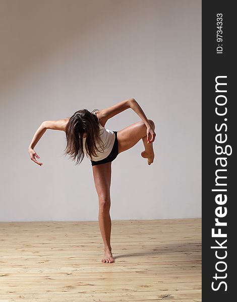 Modern style dancer posing on studio background. Modern style dancer posing on studio background