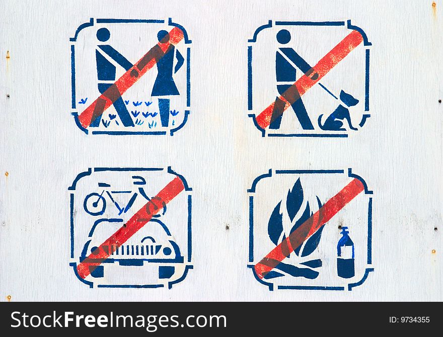Forbidding pictograms on board in park. Forbidding pictograms on board in park