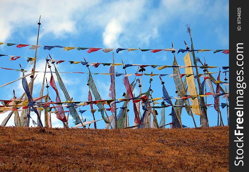 Prayer flags and poles giving strong horizontal and vertical impressions