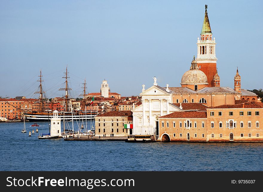 The evening view of Venice and historic ship in a background (Italy). The evening view of Venice and historic ship in a background (Italy).