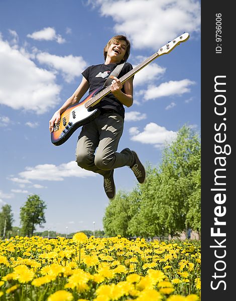 Young man jumping with bass guitar. Young man jumping with bass guitar