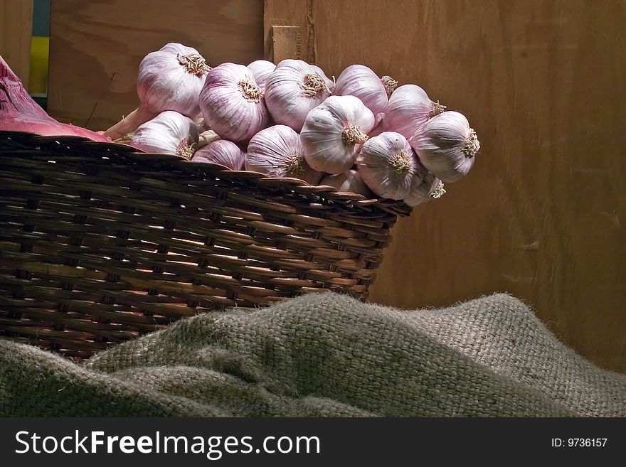 Bunch of young garlic in a wicker basket