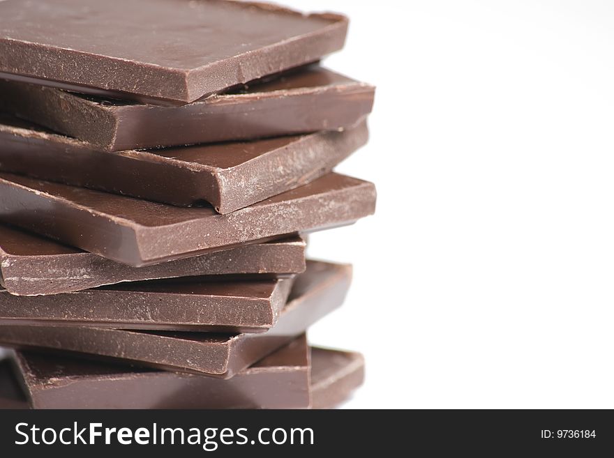Chocolate for baking on white background with shallow depth of focus