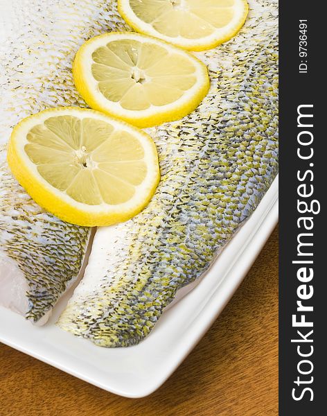 Raw Pickerel Fish Fillets with Sliced Lemon