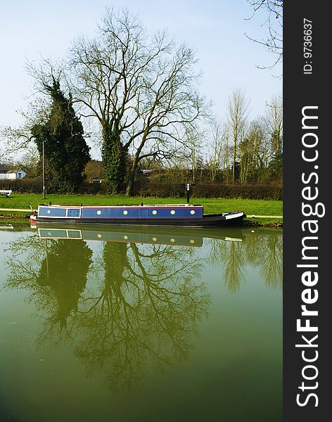 Reflections of trees and a barge on the water. Reflections of trees and a barge on the water