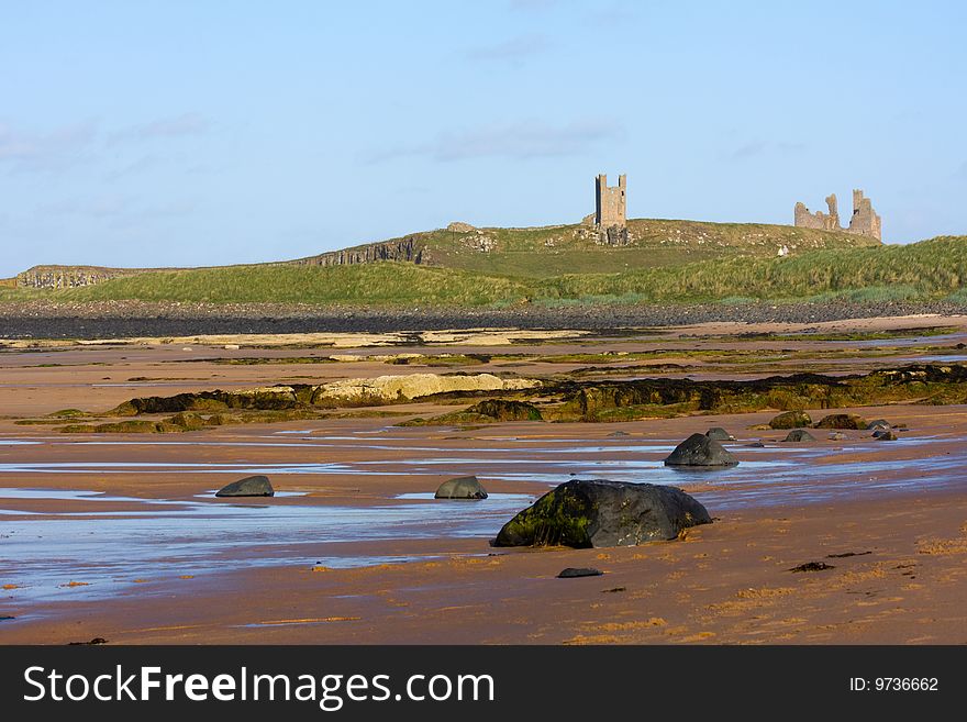 The magnificent coastline of Northumberland, featuring beach, rocks and ruined building. The magnificent coastline of Northumberland, featuring beach, rocks and ruined building