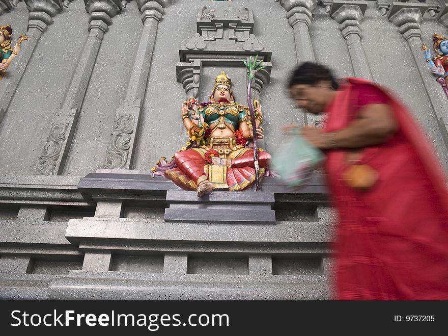 The blurred image of an old Indian woman worshipping the colorful stone wall statue of the Hindu deity Lakshmi, Goddess of wealth, prosperity, light, wisdom, fortune, fertility, generosity and courage; and the embodiment of beauty, grace and charm. ADOBE RGB (1998) color profile, the image is punchier than the preview. The blurred image of an old Indian woman worshipping the colorful stone wall statue of the Hindu deity Lakshmi, Goddess of wealth, prosperity, light, wisdom, fortune, fertility, generosity and courage; and the embodiment of beauty, grace and charm. ADOBE RGB (1998) color profile, the image is punchier than the preview.