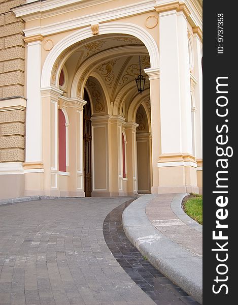 Beautiful baroque arcade with lantern with beautiful ornaments on the ceiling, and a pass leading to it