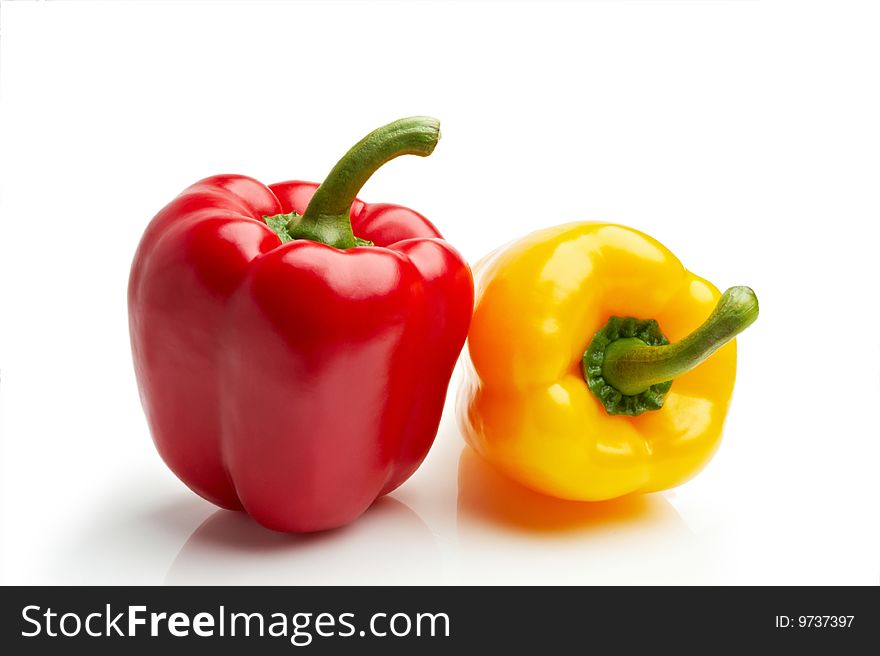 Isolated red and yellow peppers on white background
