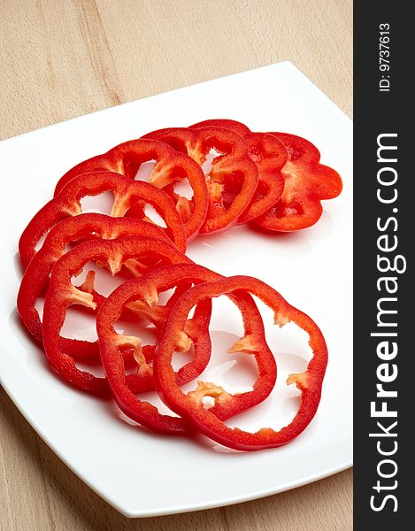 Sliced red pepper on white plate. Sliced red pepper on white plate
