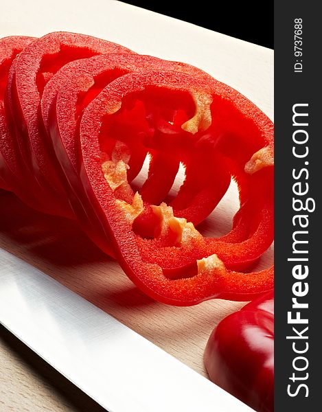 Sliced red pepper on cutting board with knife. Sliced red pepper on cutting board with knife