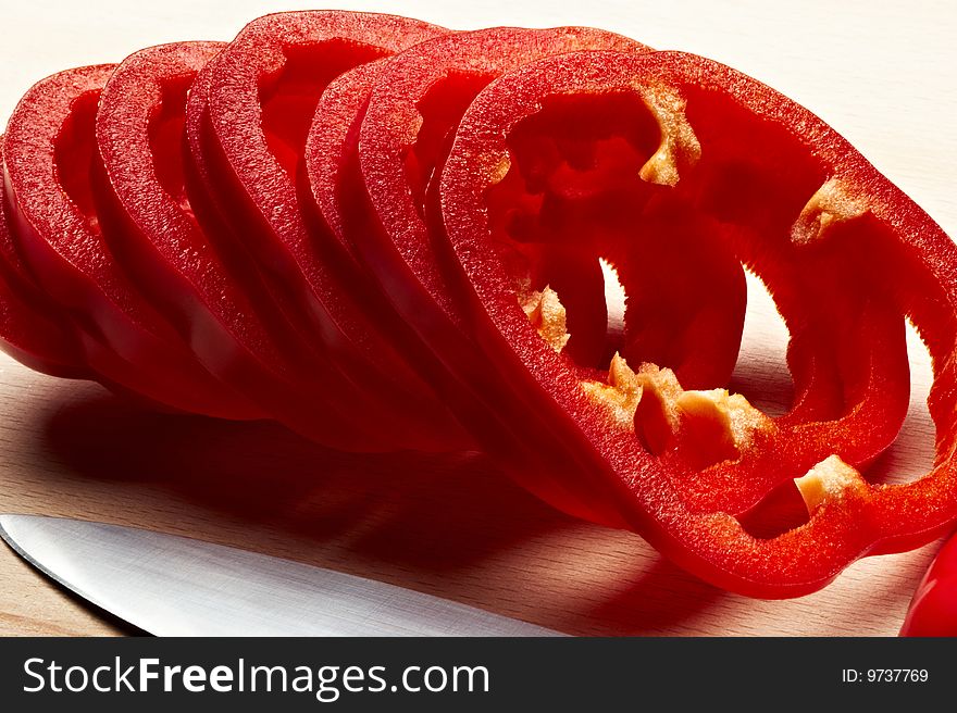 Sliced red pepper on cutting board with knife. Sliced red pepper on cutting board with knife