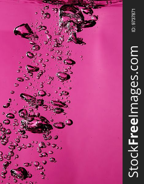 Air bubbles underwater against pink background. Air bubbles underwater against pink background